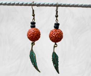 Painted Quandong and feather earrings by Dja Yingila